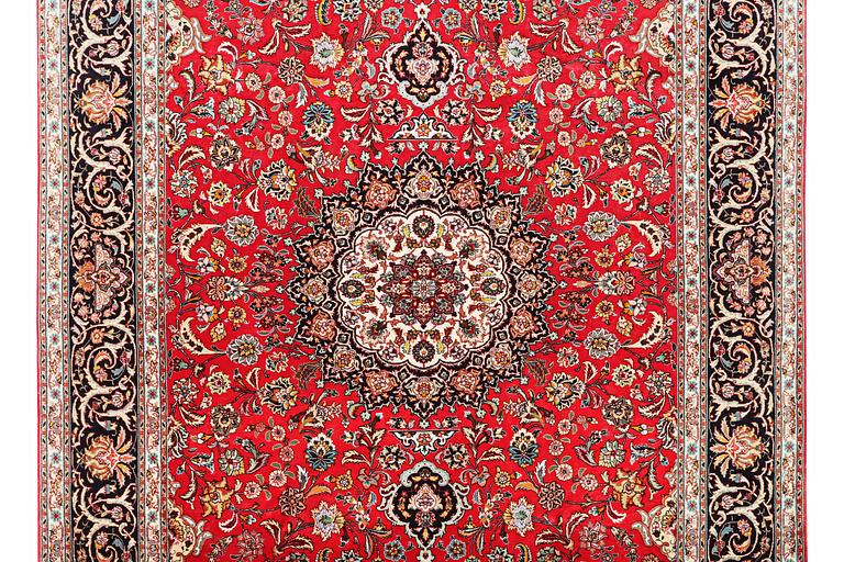 A Tabriz carpet, part silk, 50 raj, c. 325 x 208 cm.