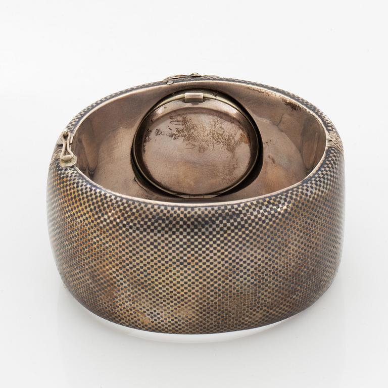 Silver bangle with watch.