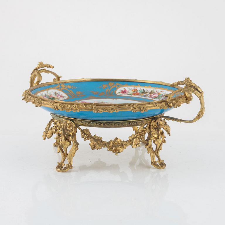 A French porcelain and brass centrepiece, second half of the 19th Century.