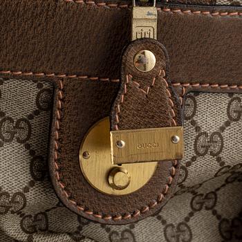 Gucci, a canvas weekend bag.