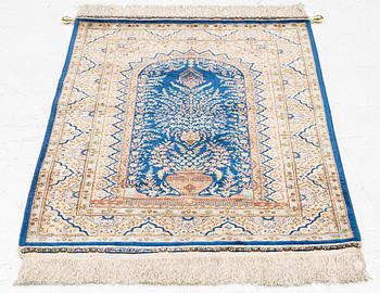 A semi-antique silk Hereke rug, West Anatolia, signed c. 107 x 72 cm.