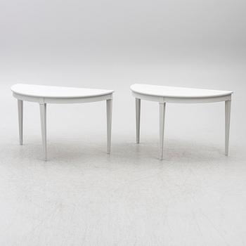 A pair of crescent shaped tables, 20th century.