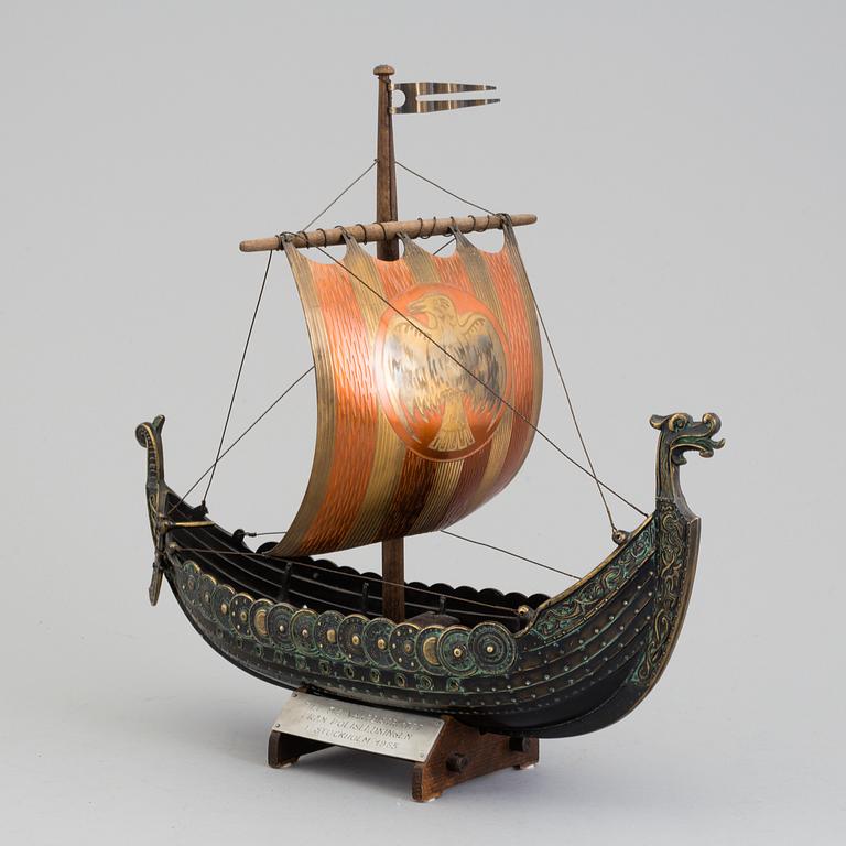 A min 20th century model of a viking ship, brass and copper.