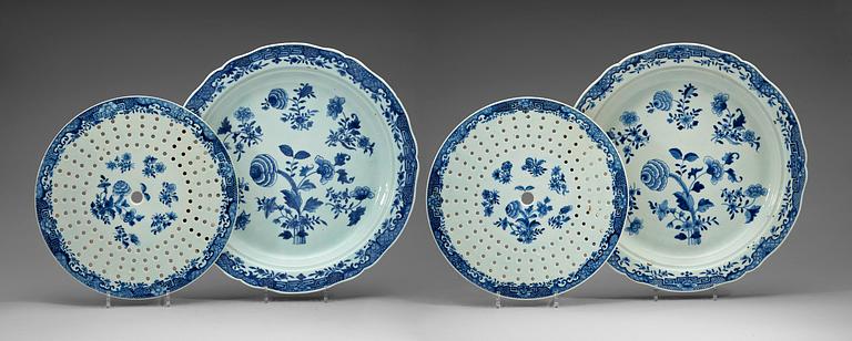 A pair of large blue and white serving dishes with strainers, Qing dynasty, Qianlong (1736-95).