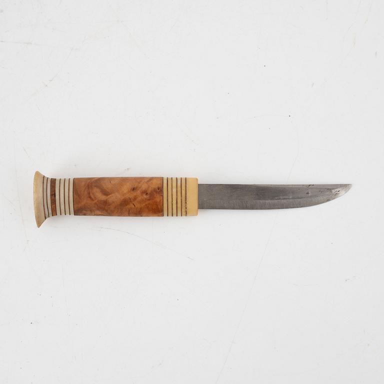 A reindeer horn knife, signed.