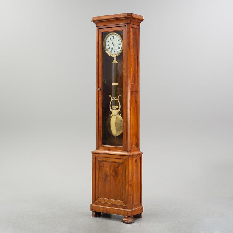 A walnut long case clock, from around the year 1900.