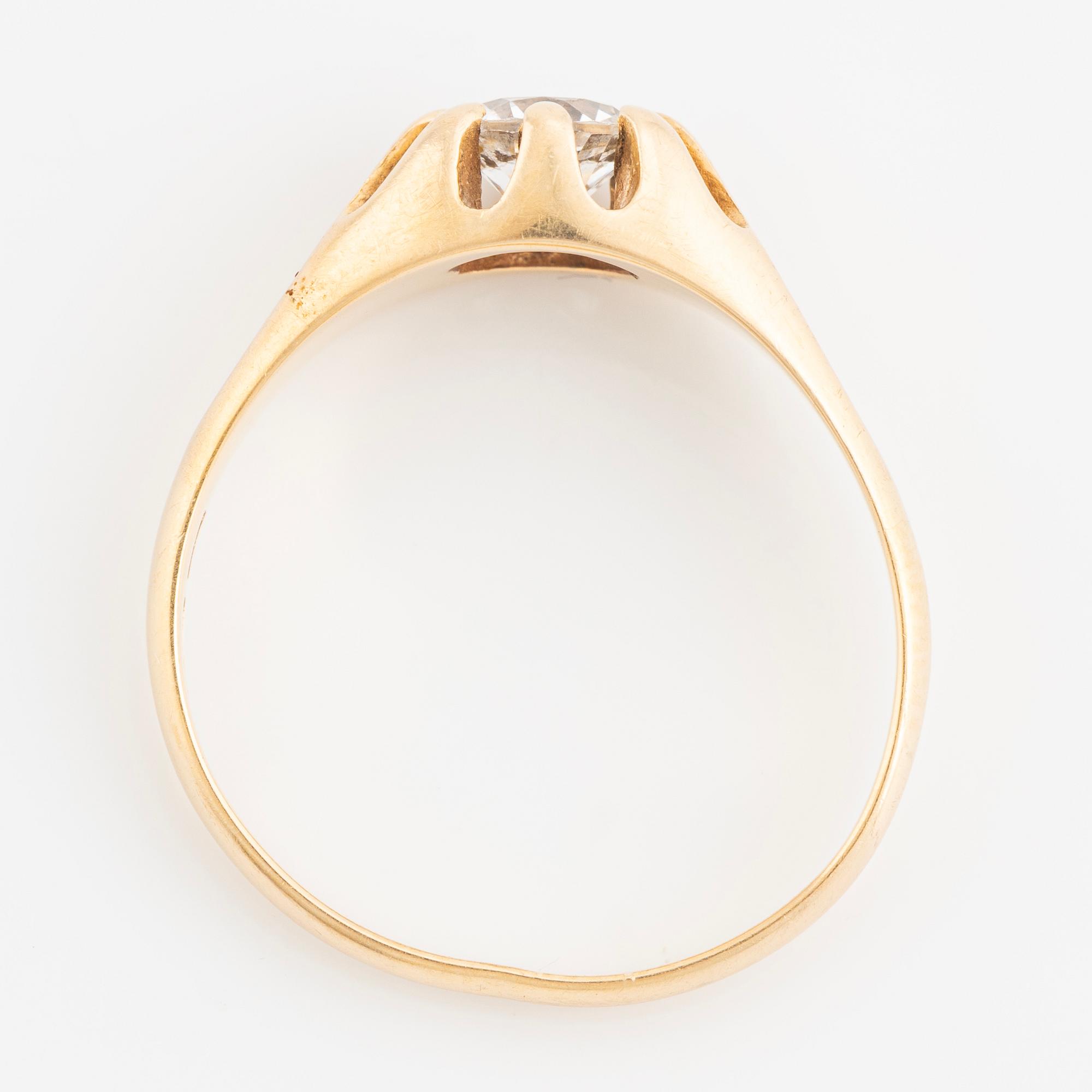Ring, with faceted white stone.