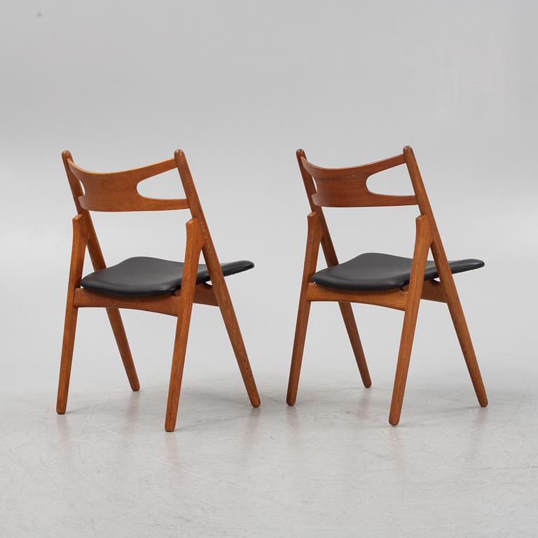 Hans J Wegner, a pair oak and teak CH29 'Savbukkestolen' chairs,Carl Hansen, mid 20th century.