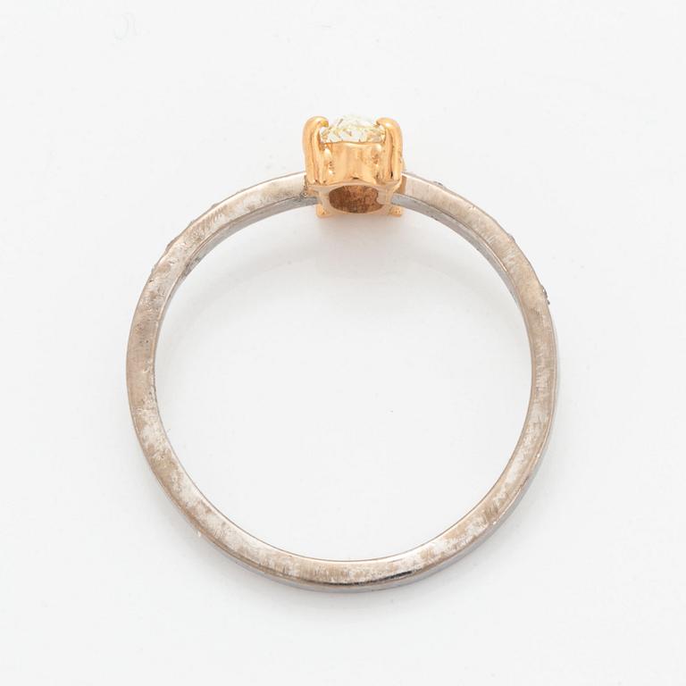 Oval diamond and brilliant-cut diamond ring.