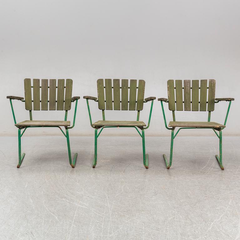 Three Arbrå stålmöbler and Grythyttan garden armchairs and a table, mid 20th century.