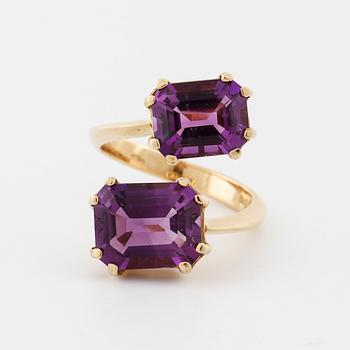 A emerald cut amethyst ring.