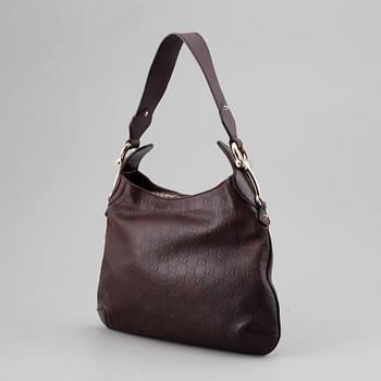 Gucci, a leather bag.