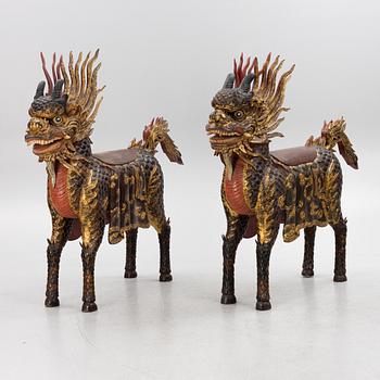 A pair of large Qilin sculptures, lacquered wood, first part of the 20th century.