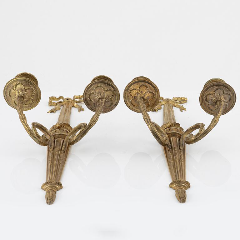 A pair of gilt brass wall sconces, Louis XVI-style, early 20th century.