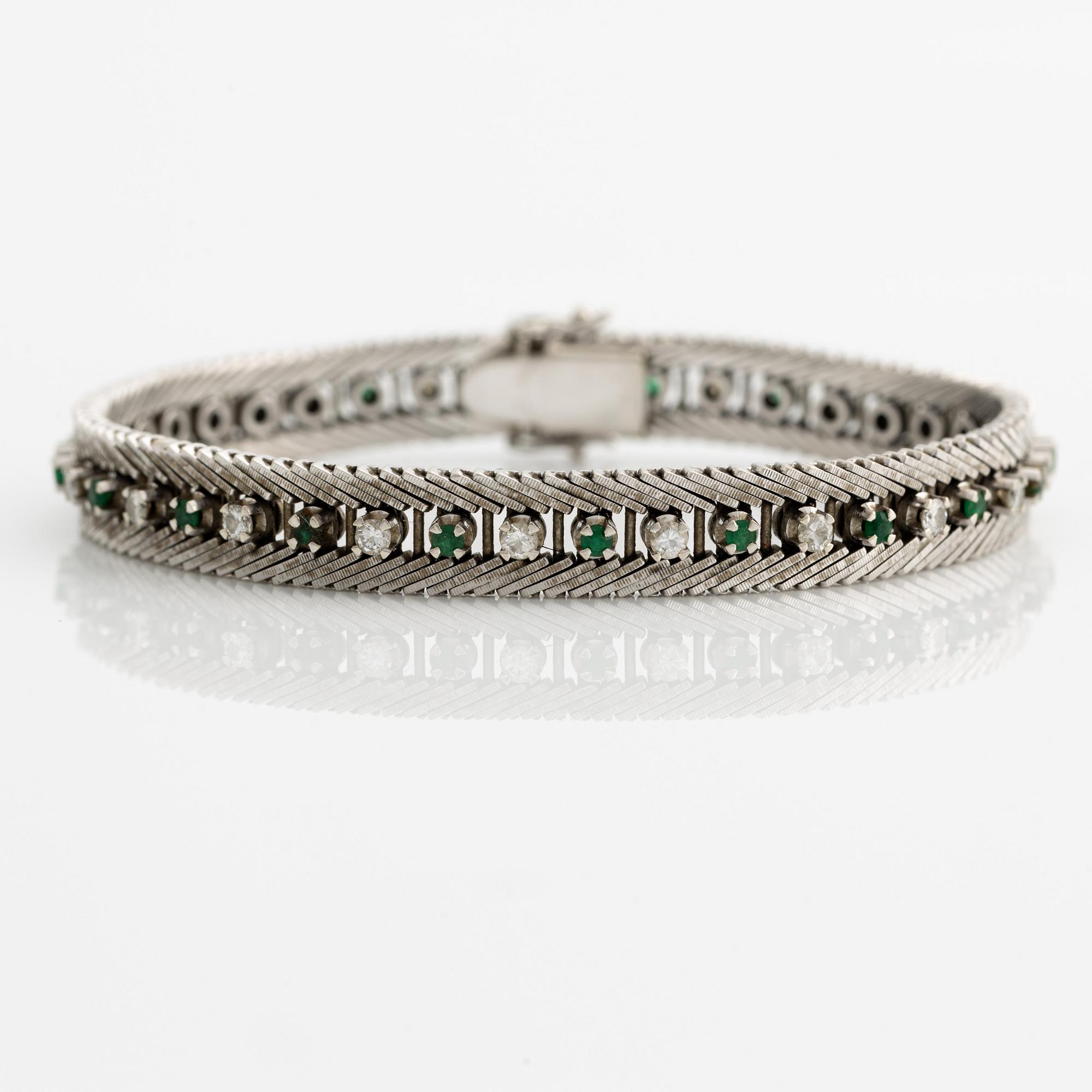 Bracelet 18K gold with round brilliant-cut diamonds and green stones, likely emeralds.