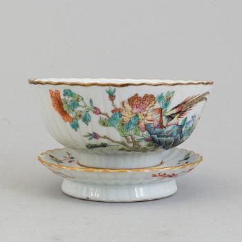 A Chinese famille rose porcelain cup with stand, Qing dynasty, Tongzhi (1862-1874), with Tongzhis mark to the base.