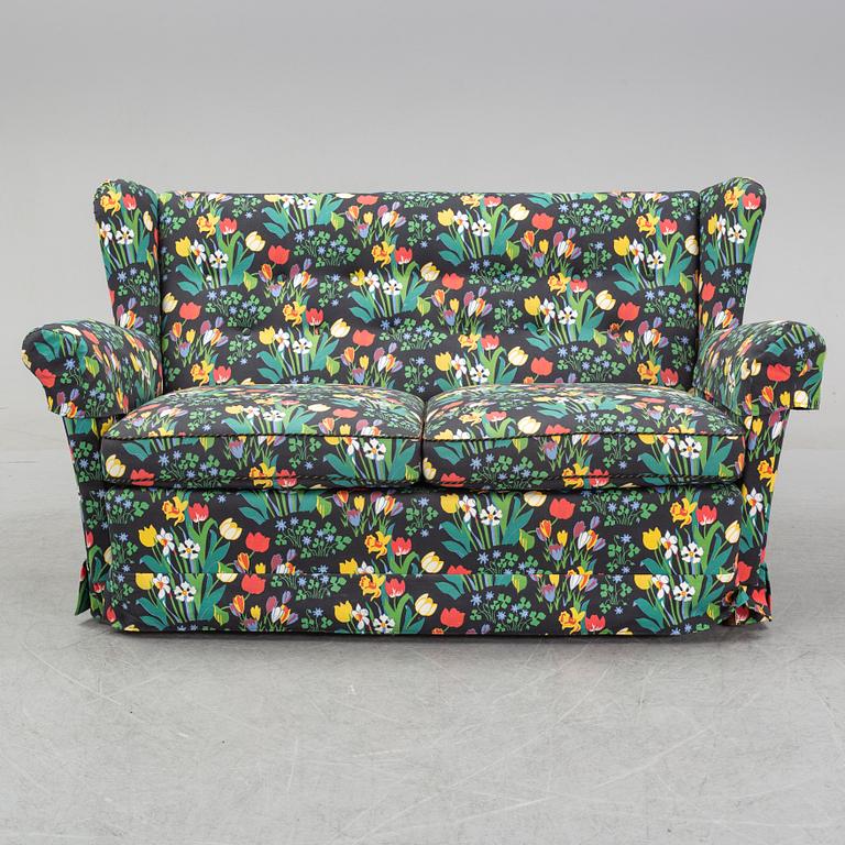 A sofa and wingback chair, later part of the 20th Century.