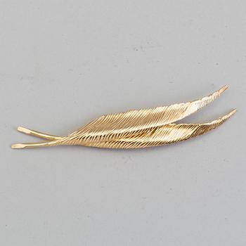 CHRISTIAN DIOR, a gilded brooch.