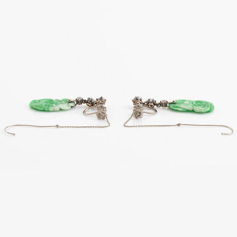 A pair of 18K white gold earrings with carved jadeite set with old-cut diamonds.