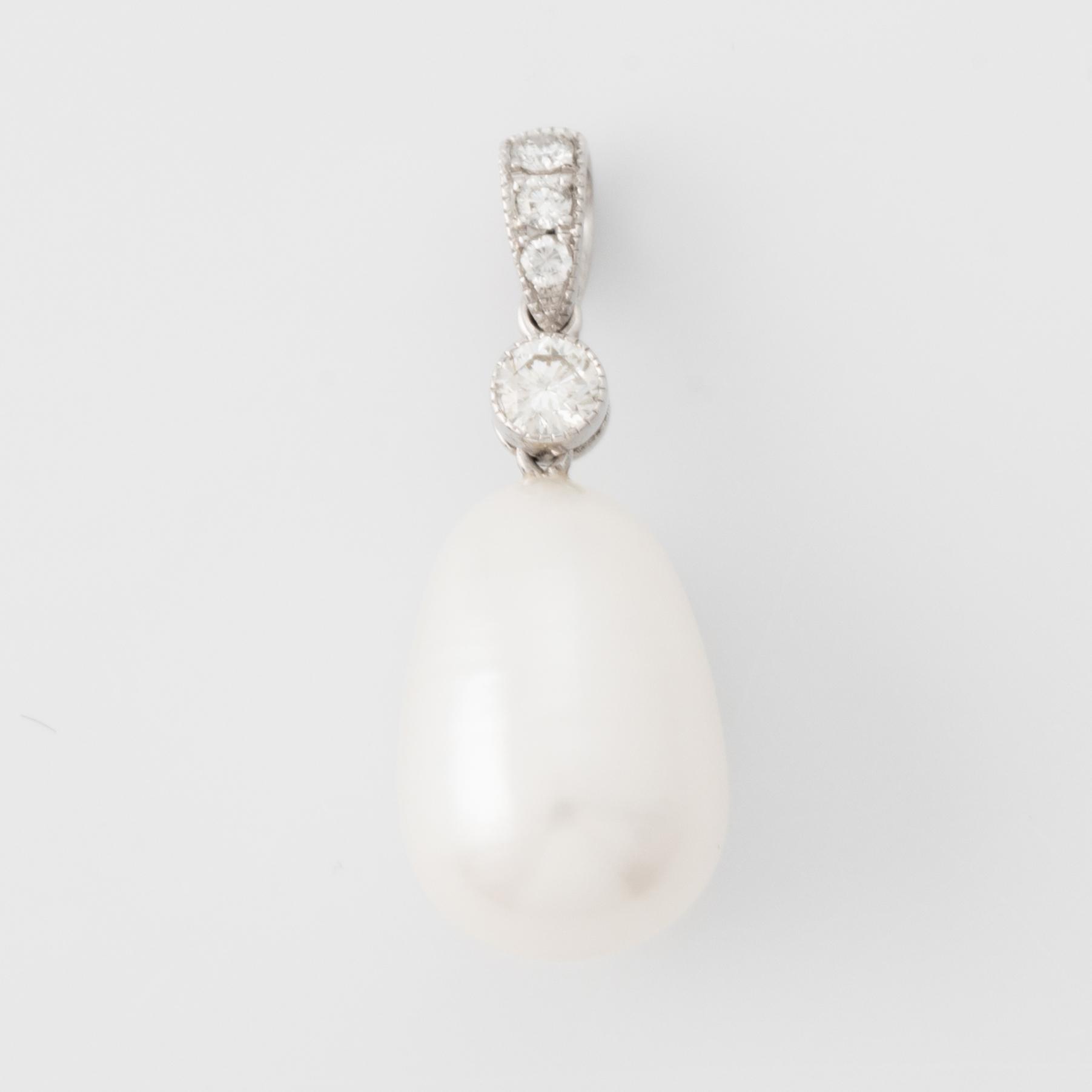 White gold pear shaped cultured pearl and brilliant cut diamond pendant.