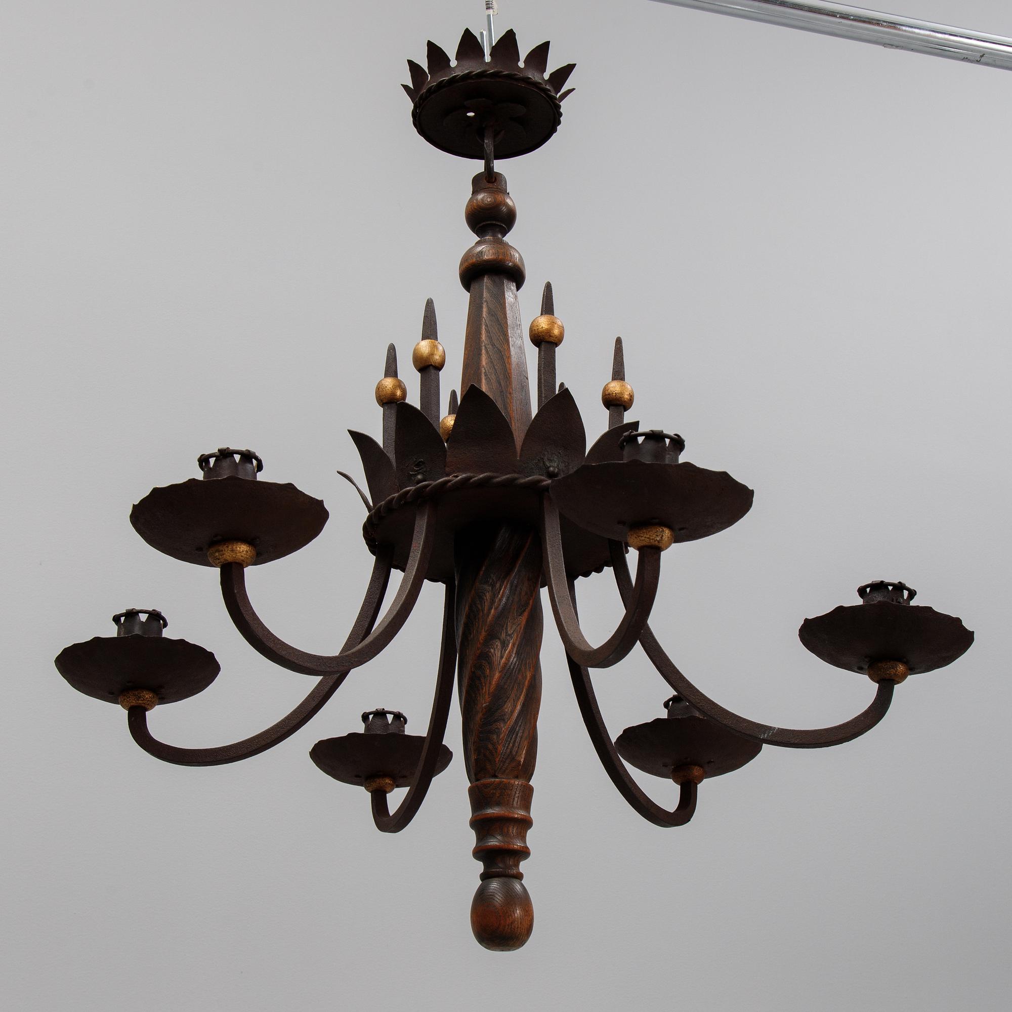 An iron and oak chandelier, 20th Century.
