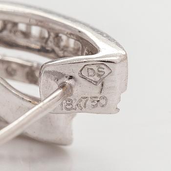 A pair of 18K white gold earrings, set with brilliant- and baguette-cut diamonds.