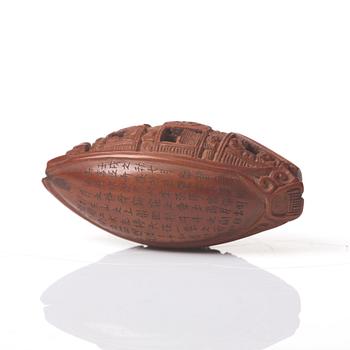 A Chinese nut boat sculpture, with poem.