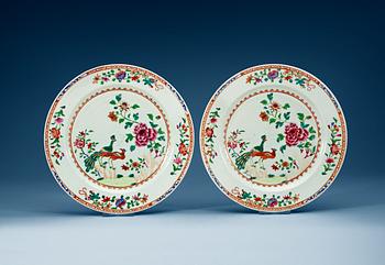 A pair of famille rose 'double peacock' chargers, Qing dynasty, Qianlong (1736-95).