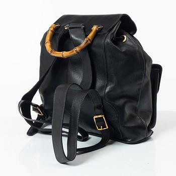 Gucci, A black leather backpack.