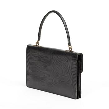 A black 1070s handbag by Hermès.