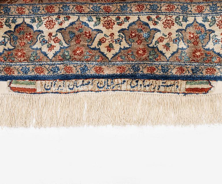 A semi-antique silk Isfahan rug, Central Persia, signed (Sadegh) Seirafian, c. 209 x 142 cm.