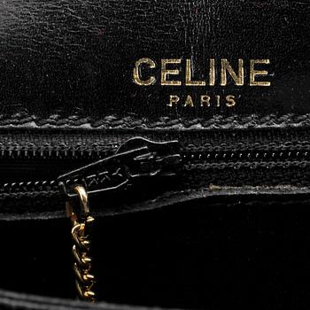 CÉLINE, a black patent leather cross-body bag.