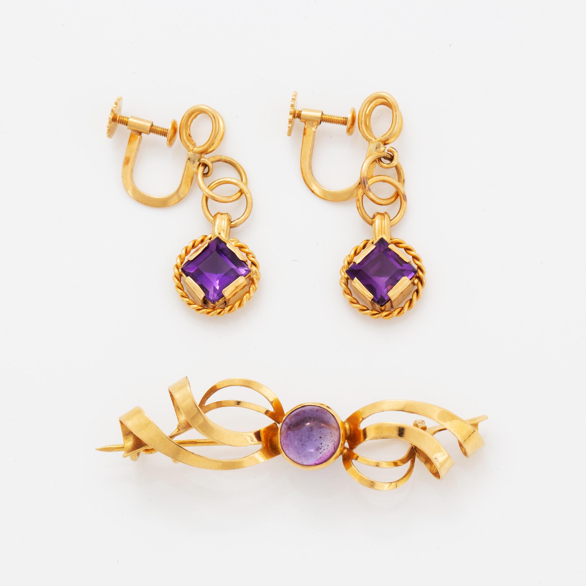 A pair of earrings and a brooch.