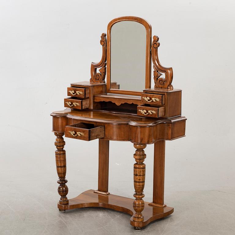 A second half of the 19th century table with mirror and a stool.