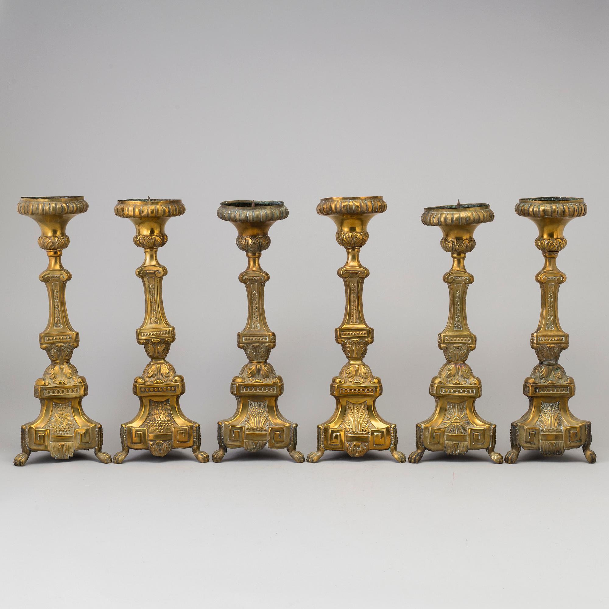 Six late 18th century brass candlesticks.