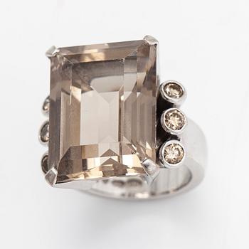 An 18K whitegold ring with an emeraldcut smokey quartz and diamonds approx 0.70 ct in total, Kultala, Helsinki 2008.