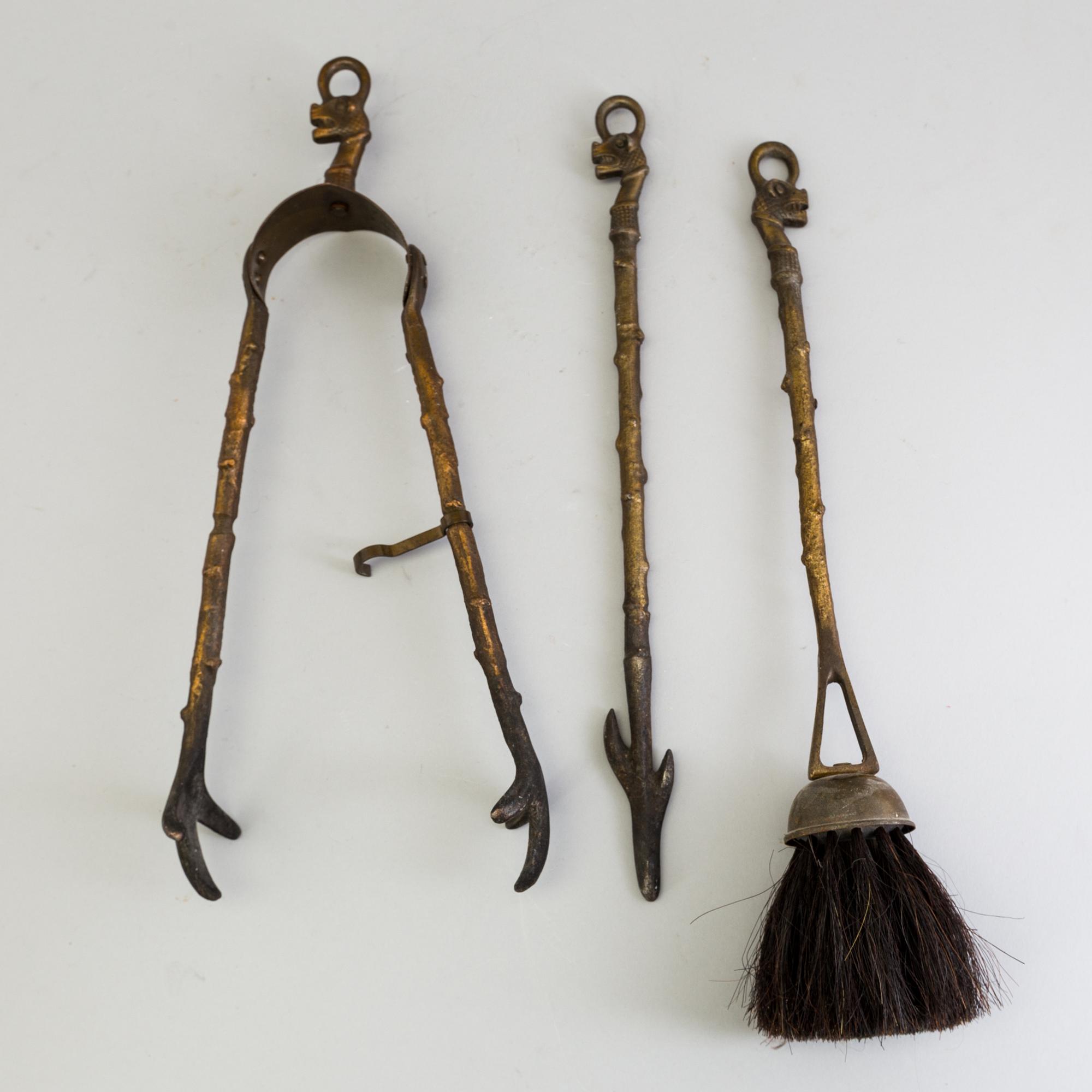 A set of three, early 20th century, bronze fire irons together with a stand, Nestor, England.