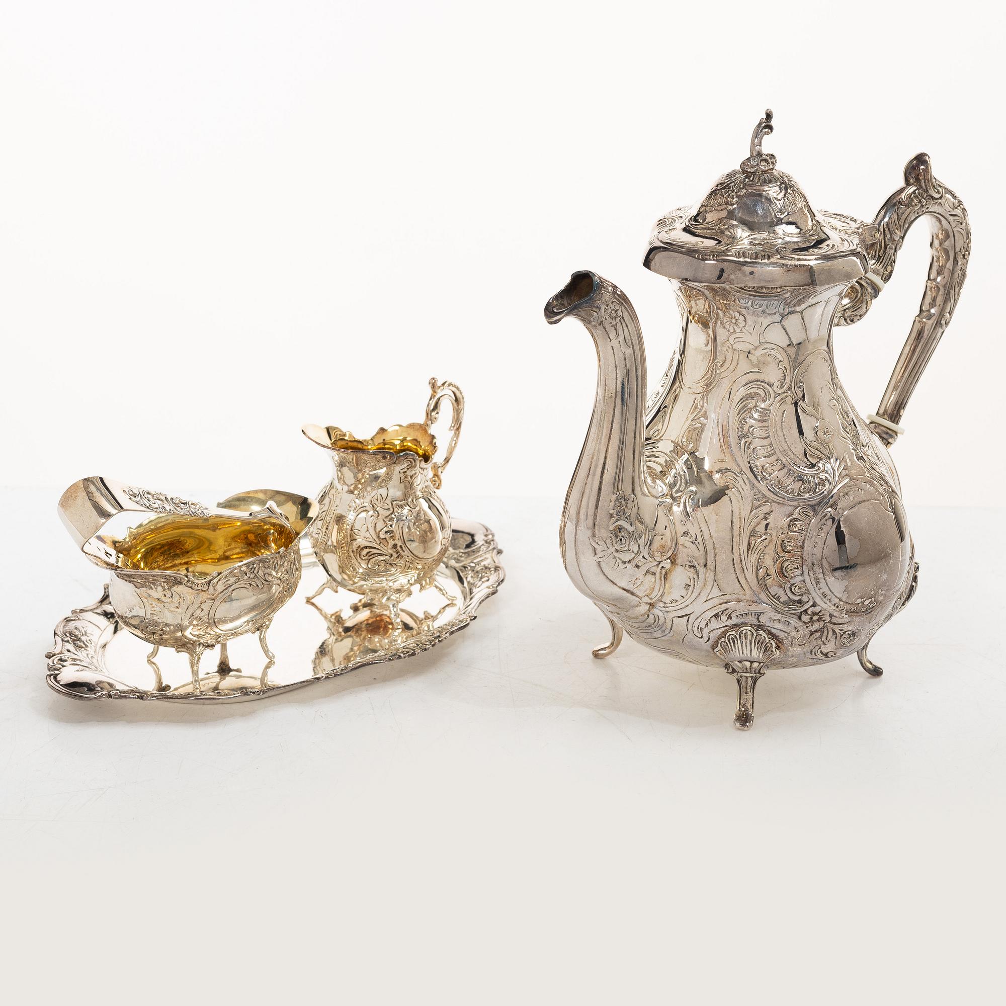 A Swedish silver Rococo style 4-piece coffee service, mark of Gewe, Malmö 1962-1978, and sugar tongs, Mylius, Norway.