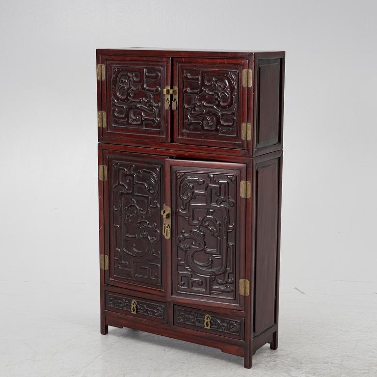 A small Chinese stained wood two part cabinet, 1900s.