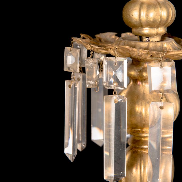 A brass chandelier with prisms, late 19th century. Height 75 cm.