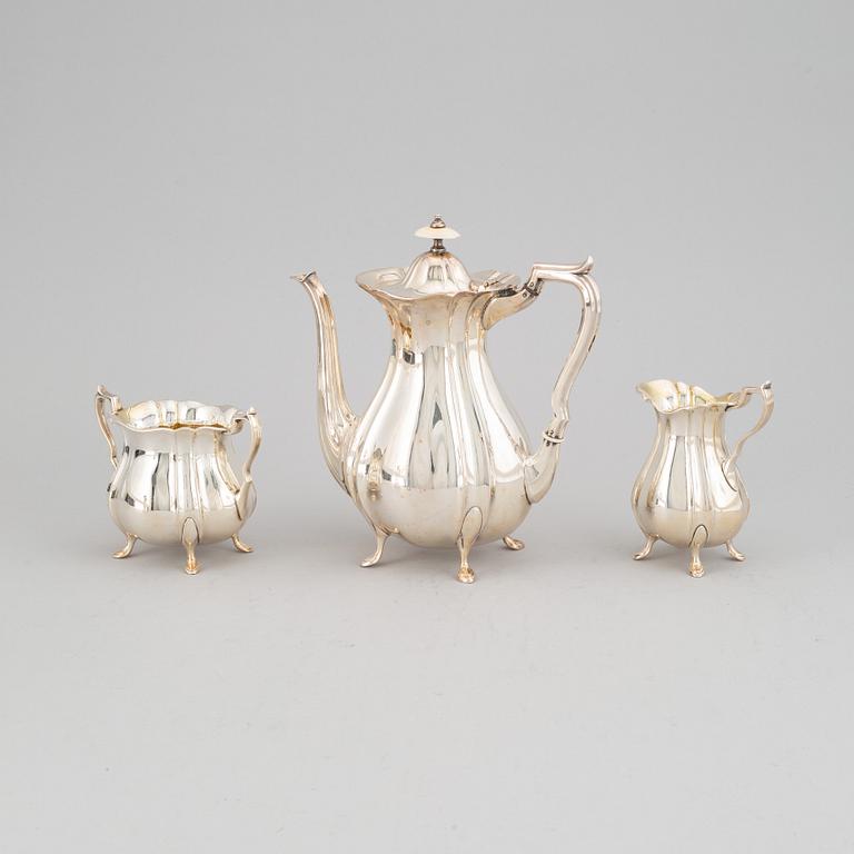 A silver coffee pot, creamer and sugar bowl and a pair of candlesticks, GAB Stockholm 1946 and Dacapo Lidköping 1988.