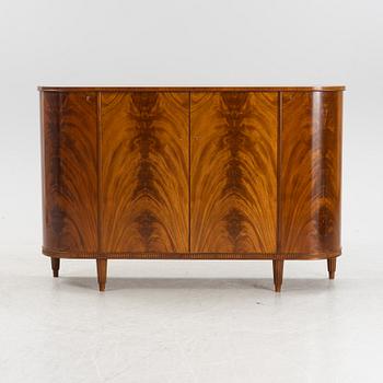 A 1940s mahogany veneered cabinet.