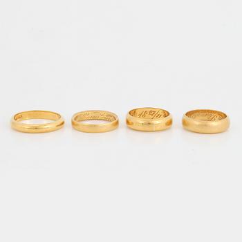 Four 23K gold rings.