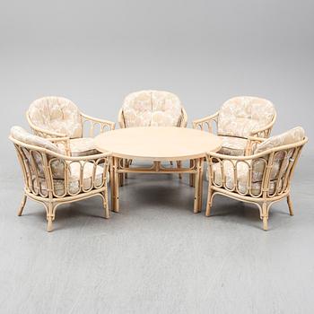 Five rattan easy chairs and a table. 1980's.