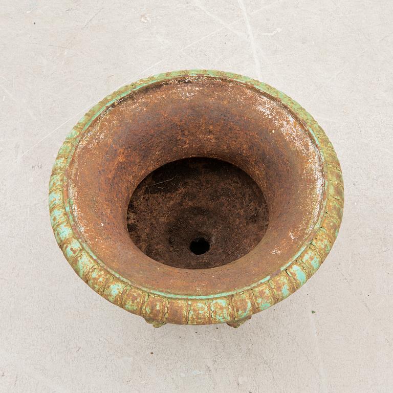 A cast iron garden urn around 1900.