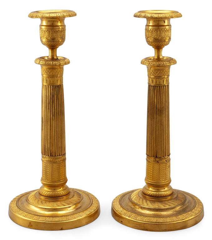 A PAIR OF EMPIRE CANDLESTICKS.