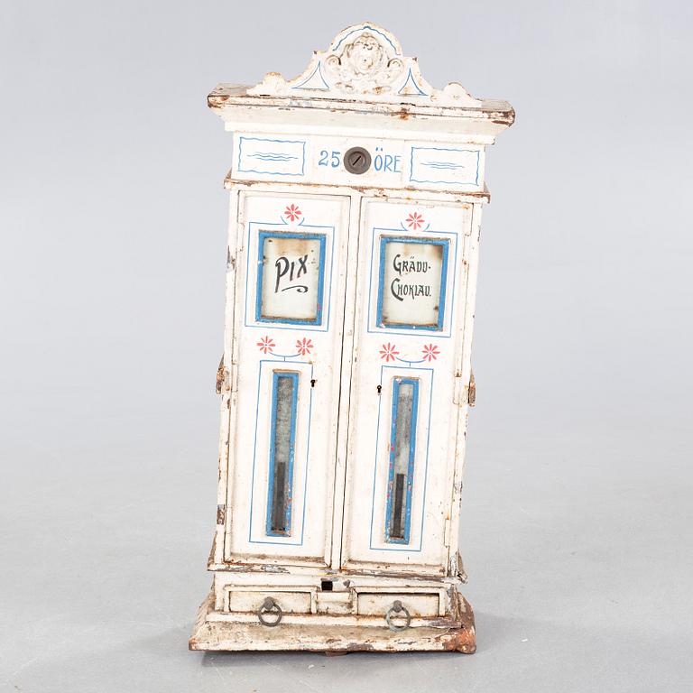 A circa turn of the century candy dispenser.