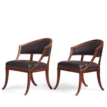 66. A near pair of mahogany open armchairs, one late Gustavian, Stockholm circa 1800.