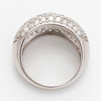 A platinum bombé ring with brilliant-cut diamonds.
