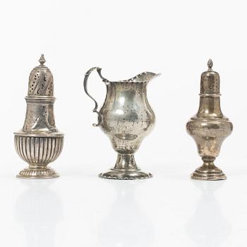 Two silver casters and cream jug, England.